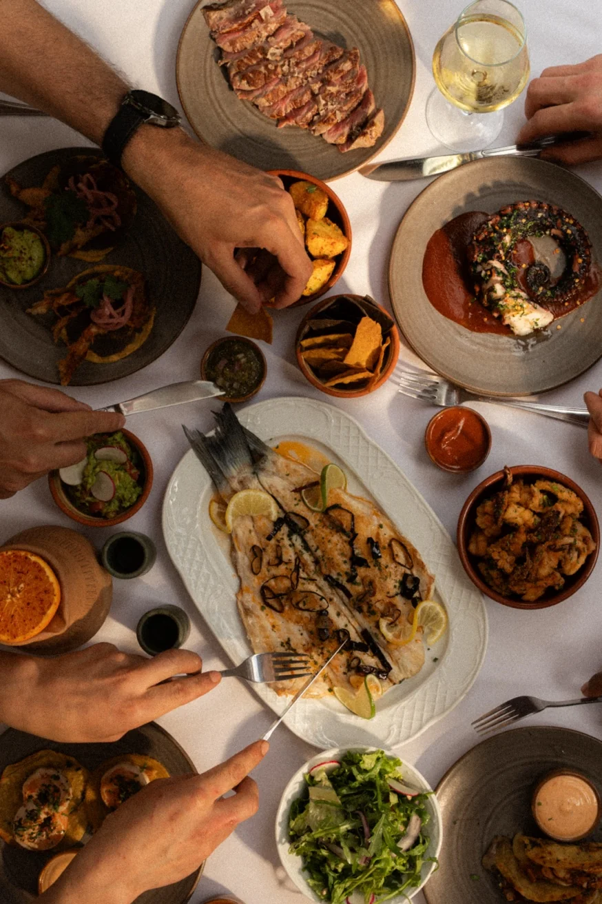 Sharing feast at Pūblico Mykonos — the best tacos in Mykonos made with handmade tortillas, Aegean seafood and authentic Mexican ingredients