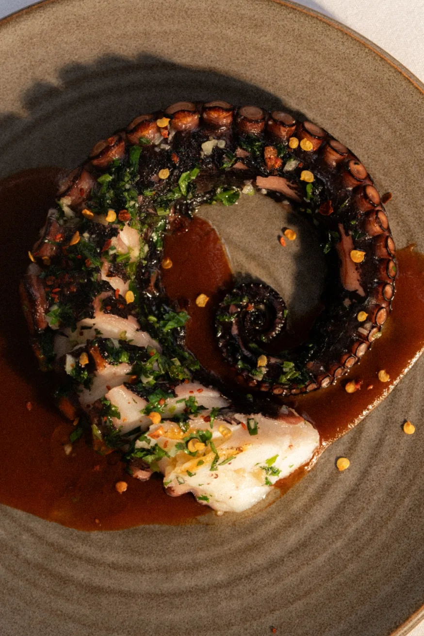 Grilled Aegean octopus with ancho chile sauce at Pūblico — authentic Mexican seafood in Mykonos Town