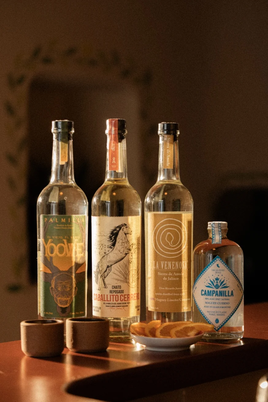 Rare artisanal mezcal bottles at Pūblico Mezcalería — curated agave spirits menu available upon request, Mykonos