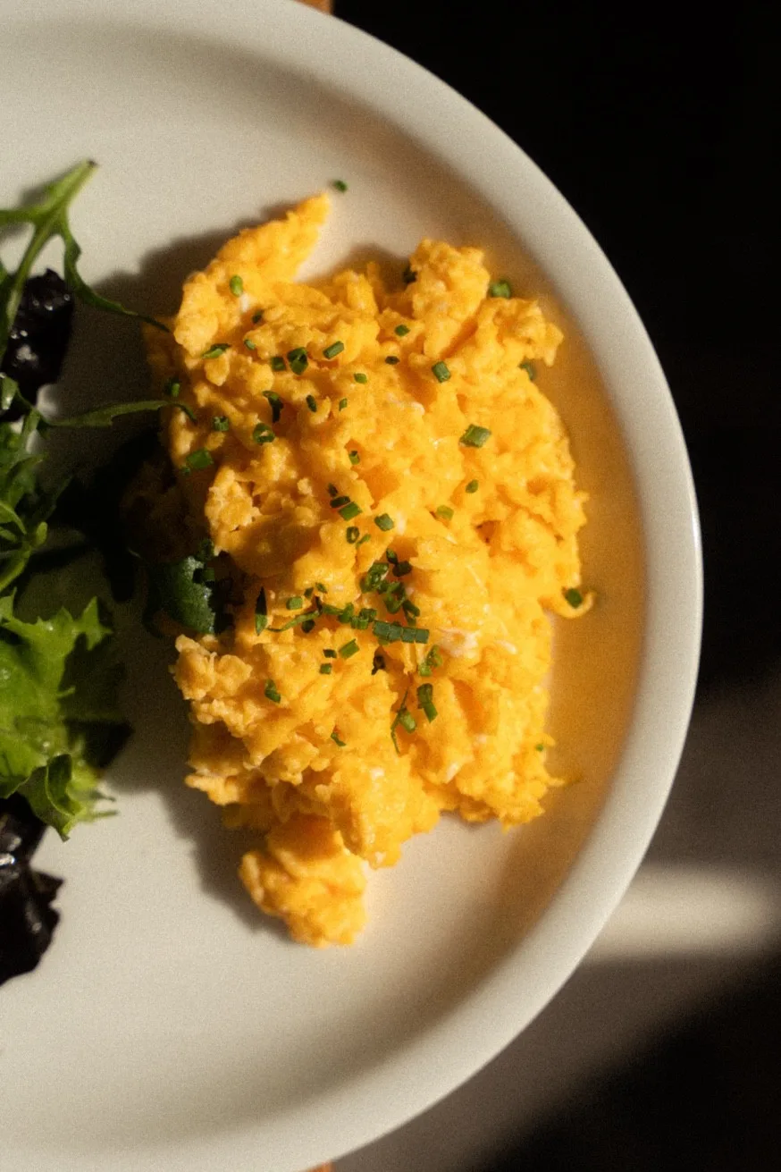 Soft scrambled eggs with fresh chives at Mykonos Brunch Club — all-day breakfast in Mykonos Town, open daily 09:00–16:00